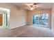 Bright bedroom featuring a ceiling fan and a sliding glass door to a balcony at 8416 Pebble Creek Way # 203, Highlands Ranch, CO 80126