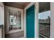 Exterior entryway showcases a vibrant turquoise door with a window on the side at 8416 Pebble Creek Way # 203, Highlands Ranch, CO 80126