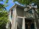 Charming condo exterior with wooden siding, bright blue accents, and staircase leading to the entrance at 8416 Pebble Creek Way # 203, Highlands Ranch, CO 80126