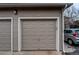 Attached single car garage in neutral color with unit number above, provides secure parking and storage at 8416 Pebble Creek Way # 203, Highlands Ranch, CO 80126