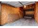 Unfinished garage space with plywood walls and concrete floor, ready to be customized for storage or workshop use at 8416 Pebble Creek Way # 203, Highlands Ranch, CO 80126