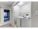 Practical laundry room features a modern washer and dryer set at 8416 Pebble Creek Way # 203, Highlands Ranch, CO 80126
