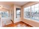 Sun-filled dining area featuring hardwood floors and views of the neighborhood at 8416 Pebble Creek Way # 203, Highlands Ranch, CO 80126