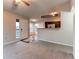 Cozy living area showcasing hardwood floors, carpet, and the kitchen at 8416 Pebble Creek Way # 203, Highlands Ranch, CO 80126