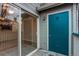 Private patio features sliding glass door and blue storage room at 8416 Pebble Creek Way # 203, Highlands Ranch, CO 80126