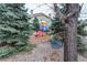 Community playground offers fun activities for all, surrounded by beautiful trees at 8416 Pebble Creek Way # 203, Highlands Ranch, CO 80126