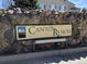 Stone sign welcomes you to Canyon Ranch with a mountain graphic and light wood tone at 8416 Pebble Creek Way # 203, Highlands Ranch, CO 80126