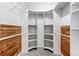 Spacious walk-in closet featuring shelving and wooden accents for optimal storage at 8416 Pebble Creek Way # 203, Highlands Ranch, CO 80126