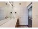 Bathroom with a wide vanity, mirror and single sink, located next to the entry door at 14251 E 1St Dr # 305, Aurora, CO 80011