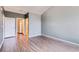 Bedroom with wood floors, neutral walls, closet and access to an ensuite bathroom at 14251 E 1St Dr # 305, Aurora, CO 80011