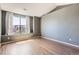 Spacious bedroom with wood floors, neutral walls, and natural light from the window at 14251 E 1St Dr # 305, Aurora, CO 80011
