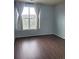 Neutral bedroom with laminate flooring, large window and a view of the neighborhood at 14251 E 1St Dr # 305, Aurora, CO 80011