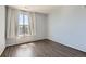 Bright bedroom featuring wood floors, neutral walls, and natural light from the window at 14251 E 1St Dr # 305, Aurora, CO 80011