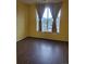Bedroom featuring laminate flooring, light yellow walls and a large sunny window at 14251 E 1St Dr # 305, Aurora, CO 80011