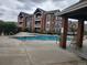 Large community pool with a brick building at 14251 E 1St Dr # 305, Aurora, CO 80011