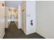 Clean hallway with numbered doors and a fire extinguisher for safety and convenience at 14251 E 1St Dr # 305, Aurora, CO 80011
