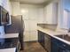 Bright kitchen featuring two toned cabinets, stainless steel appliances and wood floors at 14251 E 1St Dr # 305, Aurora, CO 80011