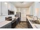 Modern kitchen features stainless steel appliances, gray lower cabinets, white upper cabinets and attractive floors at 14251 E 1St Dr # 305, Aurora, CO 80011