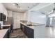 Stylish eat-in kitchen boasts stainless appliances, wood-look flooring, and a breakfast bar opening to the living area at 14251 E 1St Dr # 305, Aurora, CO 80011