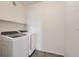 Well-lit laundry room features modern, front-loading washer and dryer with available shelf space at 14251 E 1St Dr # 305, Aurora, CO 80011