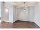 Cozy living room featuring stylish wood floors and a modern pendant light fixture at 14251 E 1St Dr # 305, Aurora, CO 80011