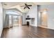 Open living space with vaulted ceiling, fireplace, sliding glass doors to the patio and hardwood floors at 14251 E 1St Dr # 305, Aurora, CO 80011