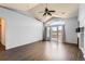 Bright living room with a vaulted ceiling, hardwood floors, and sliding glass doors at 14251 E 1St Dr # 305, Aurora, CO 80011