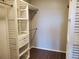 A walk-in closet with built-in shelves and dark laminate floors at 14251 E 1St Dr # 305, Aurora, CO 80011