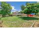 Spacious backyard featuring a deck, mature trees, and plenty of green space for outdoor activities at 8539 W Duquesne Dr, Lakewood, CO 80227