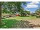 Expansive backyard featuring a large tree, lawn, and view of the home's deck and lower level at 8539 W Duquesne Dr, Lakewood, CO 80227