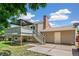Home exterior featuring a deck with a gazebo and access to a private backyard with mature trees at 8539 W Duquesne Dr, Lakewood, CO 80227