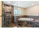 Primary bathroom featuring a luxurious soaking tub and a large walk-in shower with designer tile at 8539 W Duquesne Dr, Lakewood, CO 80227