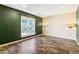 Bedroom featuring hardwood-style floors, dual sconces, and neutral paint at 8539 W Duquesne Dr, Lakewood, CO 80227