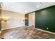Bedroom featuring hardwood-style floors, dual sconces, and neutral paint at 8539 W Duquesne Dr, Lakewood, CO 80227