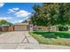Charming home with a well-manicured lawn and a spacious driveway leading to a two-car garage on a sunny day at 8539 W Duquesne Dr, Lakewood, CO 80227