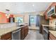 Updated kitchen features stainless steel appliances, granite counters, and stone backsplash at 8539 W Duquesne Dr, Lakewood, CO 80227