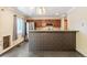 Well-lit kitchen featuring stainless steel appliances, granite countertops, a decorative half wall, and backsplash at 8539 W Duquesne Dr, Lakewood, CO 80227