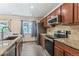 Updated kitchen features stainless steel appliances, granite counters, and stone backsplash at 8539 W Duquesne Dr, Lakewood, CO 80227
