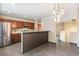 Open kitchen with stainless steel appliances, granite countertops, tiled backsplash, and a decorative half wall at 8539 W Duquesne Dr, Lakewood, CO 80227