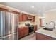 Updated kitchen features stainless steel appliances, granite counters, stone backsplash, and open layout at 8539 W Duquesne Dr, Lakewood, CO 80227