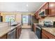 Updated kitchen features stainless steel appliances, granite counters, and stone backsplash at 8539 W Duquesne Dr, Lakewood, CO 80227