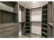 Spacious walk-in closet featuring custom shelving, drawers, and ample storage space at 8539 W Duquesne Dr, Lakewood, CO 80227