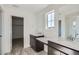 Modern bathroom with dual vanities, quartz countertops, and separate walk-in closet at 10968 Snowdon St, Parker, CO 80134