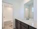 Bathroom featuring a single vanity with quartz countertops, and tiled floors at 10968 Snowdon St, Parker, CO 80134
