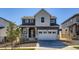 Charming two-story home featuring a two-car garage, inviting porch, and modern architectural details at 10968 Snowdon St, Parker, CO 80134