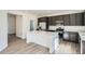 Kitchen featuring a white island, dark cabinetry, stainless steel appliances, and quartz countertops at 10968 Snowdon St, Parker, CO 80134