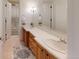 Bright bathroom featuring a double vanity with white countertop and wooden cabinets at 106 S University Blvd # 5, Denver, CO 80209