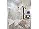 Modern bathroom featuring a frameless glass shower, marble-style tiling, and a stylish bench at 106 S University Blvd # 5, Denver, CO 80209