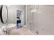 Bright bathroom featuring a pedestal sink, oval mirror, and glass-enclosed tub and shower at 106 S University Blvd # 5, Denver, CO 80209