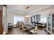 Elegant dining room featuring hardwood floors, area rug, stylish light fixture, and access to the adjacent living room at 106 S University Blvd # 5, Denver, CO 80209